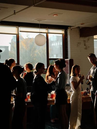 Cultural gathering crowd at arched windows — ZNTHWRLD community cultural partnership